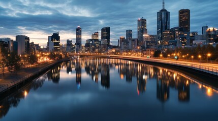 Obraz premium A stunning cityscape at dusk, featuring a shimmering river reflecting lights and modern architecture in an urban setting.