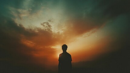Facing my Faith. Silhouette of a man looking at the beautiful sunset sky.