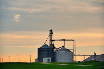 An agricultural cooperative offers a foreground for a summer sunsert in north central Illinois. The...