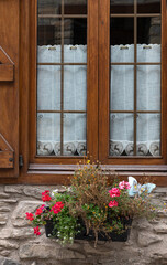 Window and window sill with floral decoration in a house in Vilac, Val D'Aran, Lleida