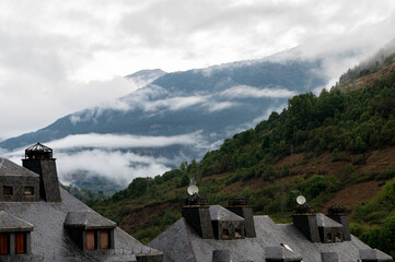 Betren houses with mountains and fog in the background, Val D'Aran, Lleida