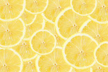 Yellow lemon slices background. Fruit pattern. Cut slices color texture. Lemon fruit section backdrop.