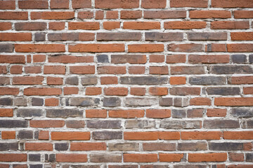Obraz premium Weathered brick wall texture with visible mortar and worn-out surface.