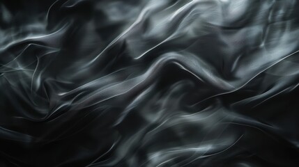 Fototapeta premium A close-up image of flowing, dark fabric with subtle light reflections