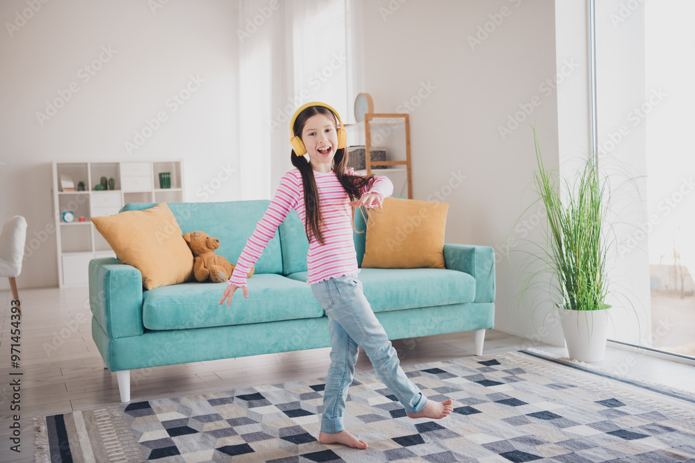 Poster Photo portrait of young funny kid energetic brunette girl staying at home listen music headphones dancing alone isolated in her room