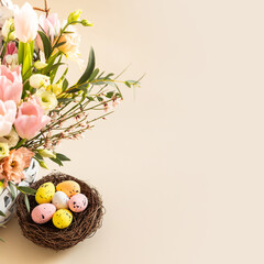Colorful easter quail eggs in nest and beautiful bouquet of rose and tulips flowers on beige pastel background. Flat lay. Spring composition. Happy passover greeting card. Copy space