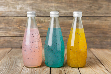 Diet detox cocktail with basil and chia seeds in a glass jar and a glass on a textured background....
