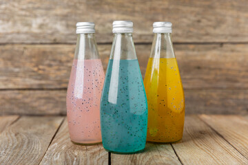 Diet detox cocktail with basil and chia seeds in a glass jar and a glass on a textured background....