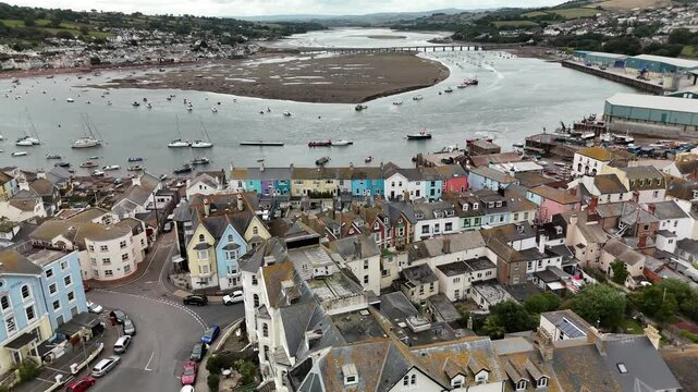 Drone flying above the coastal Teignmouth town with moored boats in water, in Devon, UK