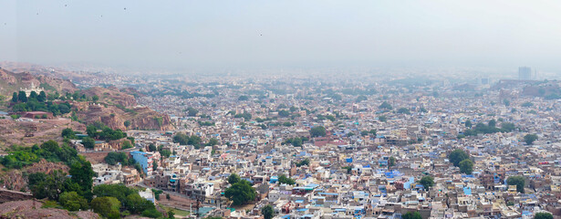 Panoramic view of Jodhpur city as seen from famous Mehrangarh fort, Jodhpur, Rajasthan, India. Blue sky in background. Mehrangarh Fort is UNESCO world heritage site popular amongst tourists worldwide.