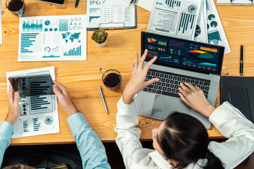 Financial data analysis dashboard by Fintech BI or business intelligence display on laptop screen to in-depth financial data analysis by business people working on business marketing. Meticulous