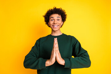 Portrait of nice young man arms plead wear sweater isolated on yellow color background