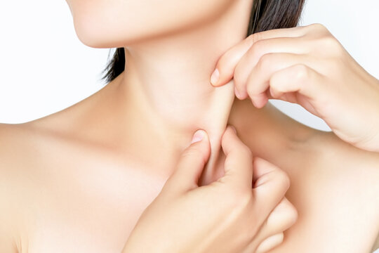 woman massaging her neck and clavicular mastoid muscle (Sternomastoid Muscle, Stemocleidomastoid Muscle). wellness self-massage at home concept