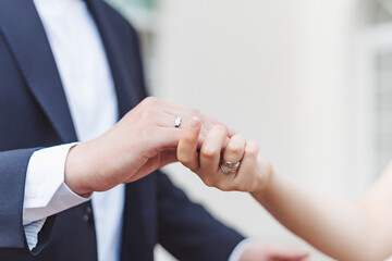 Obraz premium A couple exchanging rings in a heartfelt moment during their outdoor wedding ceremony on a sunny afternoon