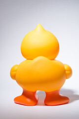 Rubber, duck and back in studio for bath, playing and children entertainment with fun squeaky sound. Plastic bird, toy and white background for kids, pool and water with childhood games or activity