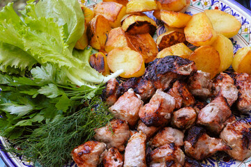 Roast Pork And Potatoes In A Large Plate On A Wooden Table. Shashlik And Potatoes With Salad.