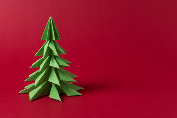 Christmas tree made of green paper. Minimal New Year background with copy space.