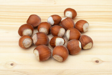 Hazelnuts in shell on a wooden background