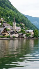 Enjoy the peaceful summer atmosphere in Hallstatt, Austria, where clear lake waters reflect a picturesque village and majestic mountains under a bright blue sky