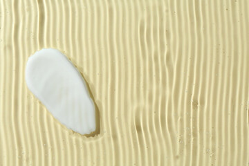 Samples of cosmetic products on beige background, top view