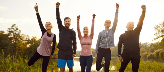 Sport team, cheerful diverse young friends standing together outdoors before start training giving hand up gesture, feel happy and healthy, good running result celebration, marathon race, competition