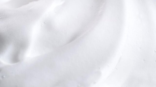 Beauty background with foam mousse, macro. Close up of white cloud of shaving mousse foam.