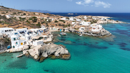 Aerial drone photo of picturesque seaside area and bay of Goupa - Karra with colourful boat houses and elephant rock a perfect place to swim, Kimolos island, Cyclades, Greece