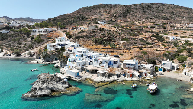 Aerial drone photo of picturesque seaside area and bay of Goupa - Karra with colourful boat houses and elephant rock a perfect place to swim, Kimolos island, Cyclades, Greece