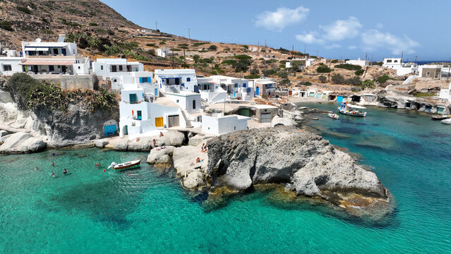 Aerial drone photo of picturesque seaside area and bay of Goupa - Karra with colourful boat houses and elephant rock a perfect place to swim, Kimolos island, Cyclades, Greece