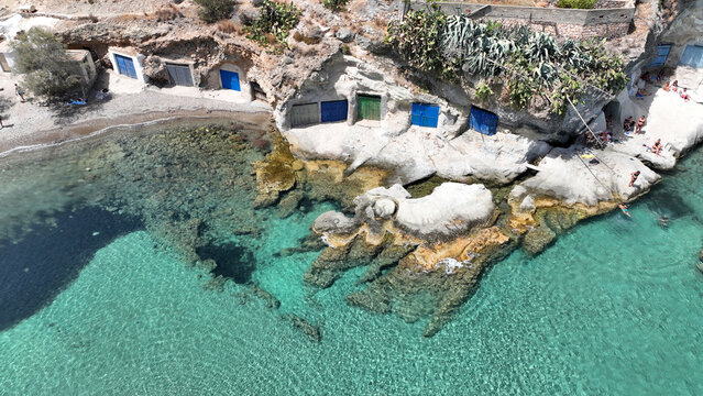 Aerial drone photo of picturesque seaside area and bay of Goupa - Karra with colourful boat houses and elephant rock a perfect place to swim, Kimolos island, Cyclades, Greece