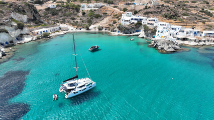 Obraz premium Aerial drone photo from tropical exotic paradise secluded rocky island bay with deep turquoise and sapphire sea forming a blue lagoon visited by yachts and sail boats in Caribbean exotic destination