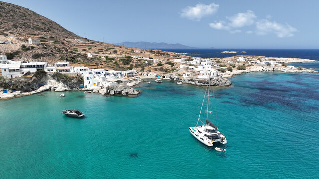 Aerial drone photo of picturesque seaside area and bay of Goupa - Karra with colourful boat houses and elephant rock a perfect place to swim, Kimolos island, Cyclades, Greece