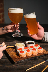 Enjoying craft beer and sushi on a cozy evening at a trendy culinary spot with friends, creating vibrant flavors and memorable moments