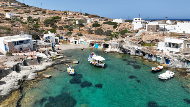 Aerial drone photo of picturesque seaside area and bay of Goupa - Karra with colourful boat houses and elephant rock a perfect place to swim, Kimolos island, Cyclades, Greece