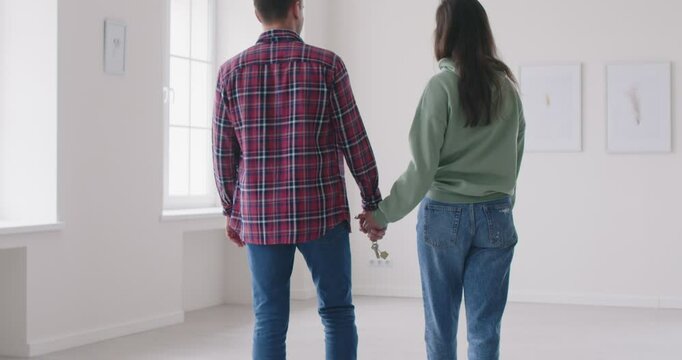 Surveying vacant rooms of their new house young couple eagerly plans their upcoming move, envisioning how they will fill each space with love and memories setting stage for their fresh start together