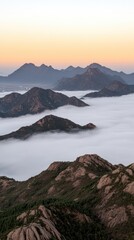 Fototapeta premium The sun sets behind clouds in Shandong, illuminating mountains and a foggy sea beneath. A solitary pine tree frames the scene, enhancing the tranquil beauty of the landscape