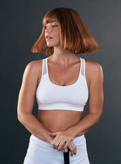 Woman, confidence and hockey in studio for sports, fitness or exercise on gray background with stick. Female person, athlete and ready for practice, training and game with equipment, uniform or skill