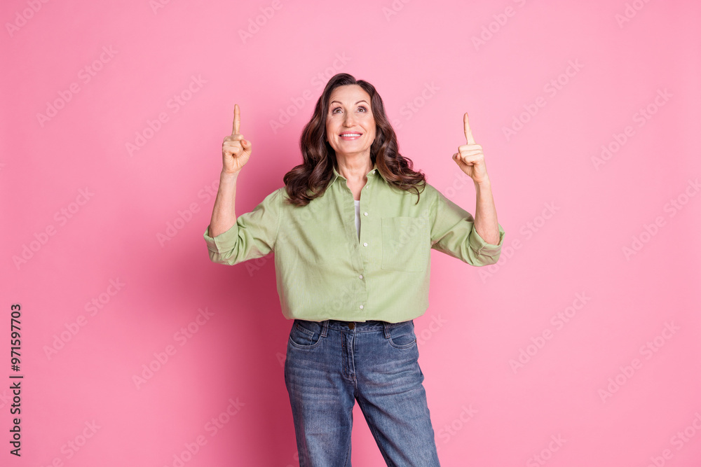 Canvas Prints Photo portrait of retired successful business woman wearing khaki shirt direct fingers above showing isolated on pink color background