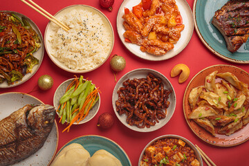 Vibrant chinese new year traditional dishes on a festive red background: kung pal chicken, sweet...