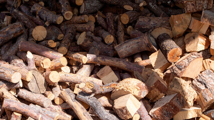 Pile of chopped and stacked firewood for heating or campfire