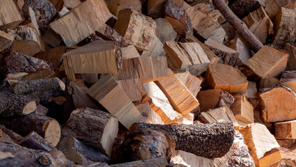 Pile of chopped and stacked firewood for heating or campfire