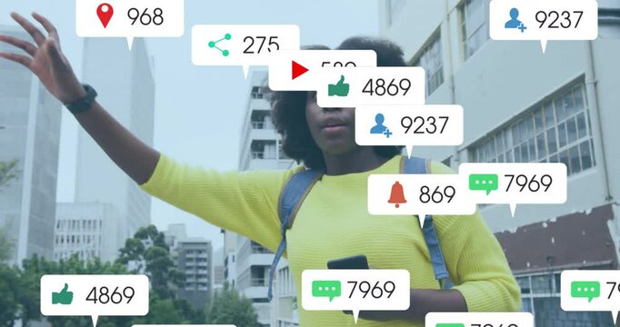 Animation of media icons over african american woman hailing taxi in city