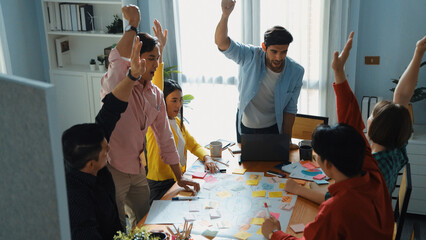 Top view of happy creative team putting hands together while drawing mind map. Group of diverse people working together brainstorming marketing idea and sharing plan by using sticky notes. Convocation