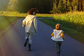 the child runs after his mother, a fun family outdoor game. happy childhood