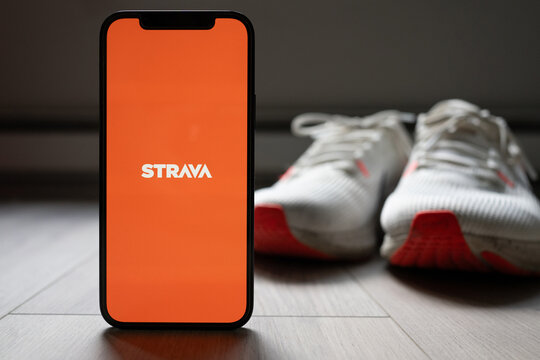 Phone with Strava App on the Screen with Running shoes in the background