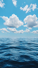 Obraz premium Vast ocean horizon with fluffy white clouds floating above, creating serene atmosphere