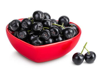 Chokeberry in ceramic bowl isolated on white background. Black aronia.