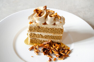 coffee almonds cake in white plate on loft background