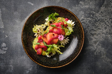 gourmet salmon salad on a dark rustic background