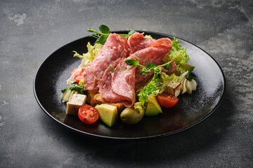  gourmet antipasto platter with assorted meats, cheeses, and fresh vegetables